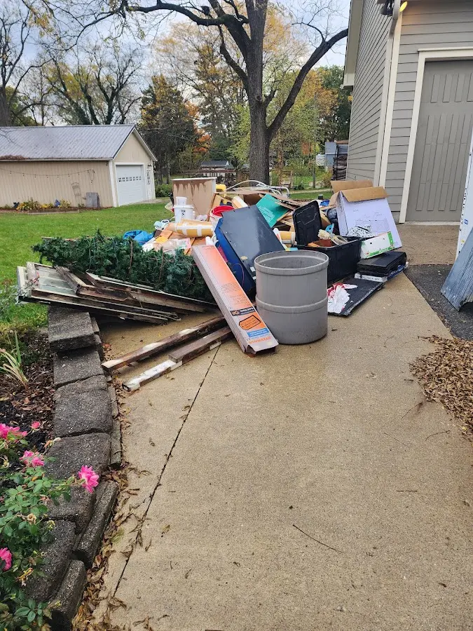Dumpster being loaded with debris for Estate Cleanout Dumpster Rental in Pantops